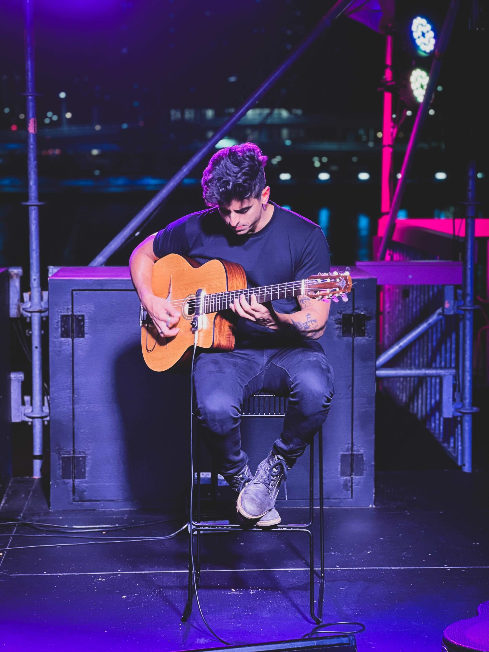 image of a flamenco guitarist playing live on theatre stage.